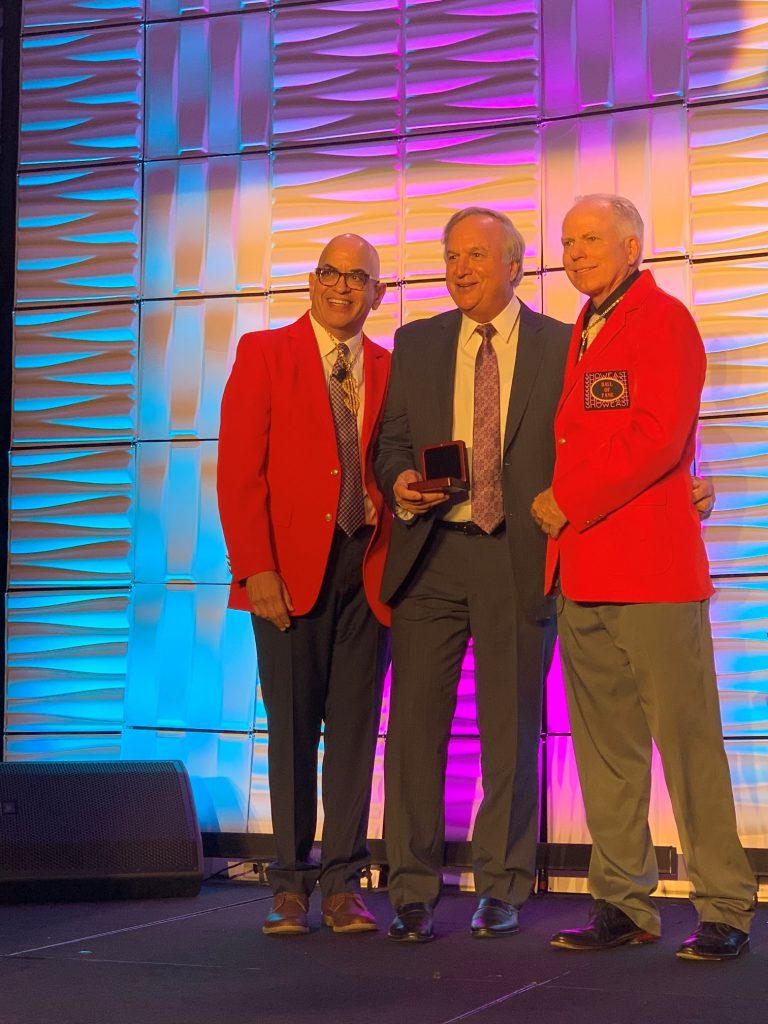 Jack Kline, center, receiving his award from left Jeff Goldstein of Warner Bros. Pictures and right Clark Woods of iPic Entertainment, Inc.