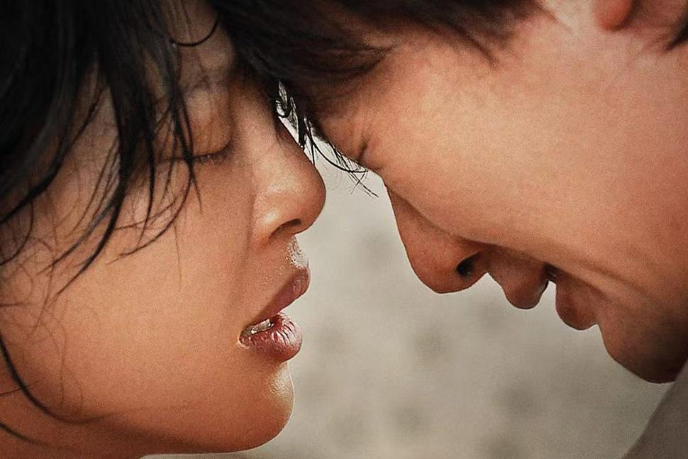 Zhilei Xin (left) and Shaofeng Feng press their heads together, eyes closed, in "The Sun Rises On Us All"