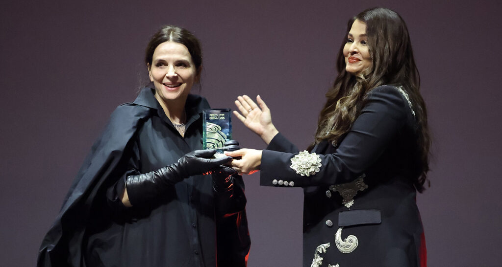 Aishwarya Rai Bachchan presents an honouree award to Juliette Binoche (L) onstage during the Opening Ceremony at the Red Sea International Film Festival 2025 on December 04, 2025 in Jeddah, Saudi Arabia
