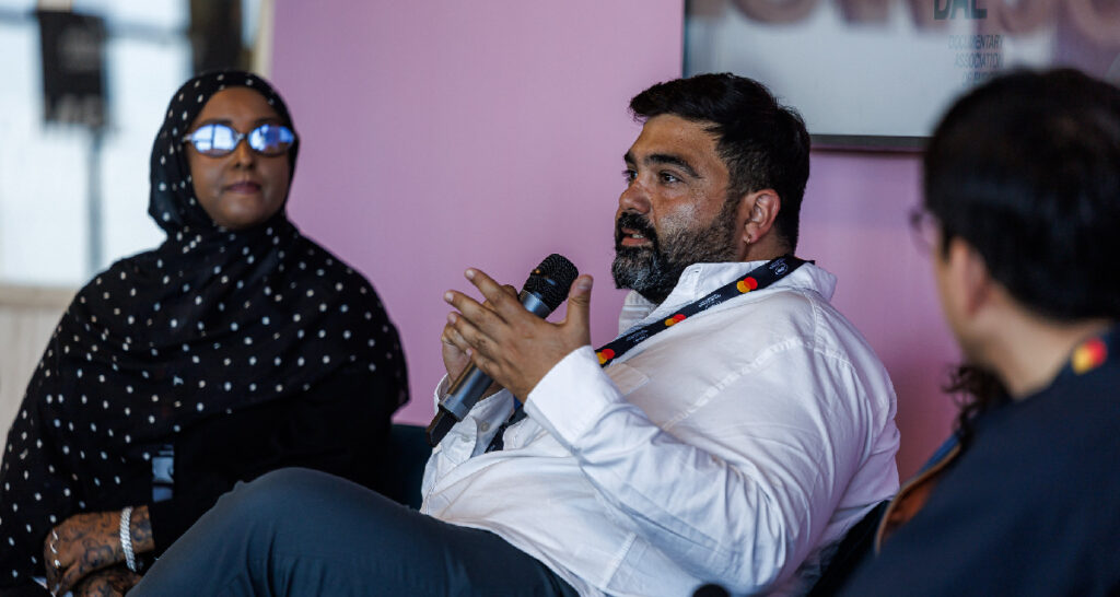 Can Sungu, artistic director of SİNEMA TRANSTOPIA (centre) and Ruun Nour, Vancouver International Film Festival programmer and No Evil Eye Cinema co-founder, during the Cannes Docs panel “Micro Cinemas and Macro Impact: Independent Exhibition as a Social and Communal Practice,” held on May 16, 2026 (Photo: © Cyril Chateau / Marché du Film)