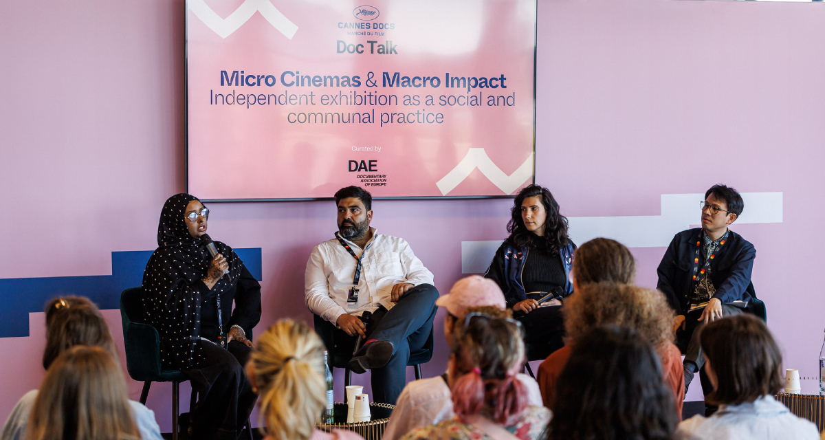 (From left) Ruun Nour, Vancouver International Film Festival programmer and No Evil Eye Cinema co-founder; Can Sungu, artistic director of SİNEMA TRANSTOPIA; Kira Simon-Kennedy, film producer and volunteer member with La Clef collective; and moderate Jeremy Chua, producer at Potocol and executive director of the Singapore International Film Festival, who participated in the Cannes Docs panel “Micro Cinemas and Macro Impact: Independent Exhibition as a Social and Communal Practice,” held on May 16, 2026 (Photo: © Cyril Chateau / Marché du Film)