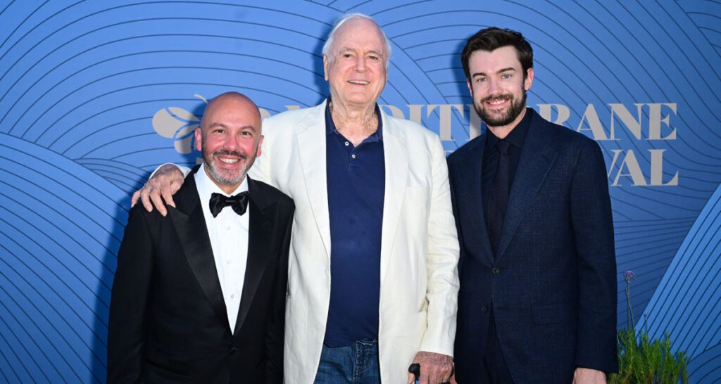 (From Left) Malta Film Commissioner Johann Grech attends the Mediterrane Film Festival's Golden Bee Awards with host Jack Whitehall and Icon award winner John Cleese. The awards took place on June 29, 2026 (Photo: Anthony Harvey/Shutterstock for Mediterrane Film Festival)
