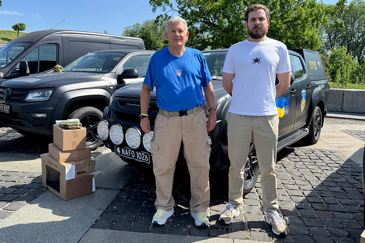 Flix Brewhouse Founder and Executive Chair, Allan Reagan, (left) in Kyiv, Ukraine handing over a donated vehicle to a member of the Ukranian military after a NAFO Convoy in May of 2026.
