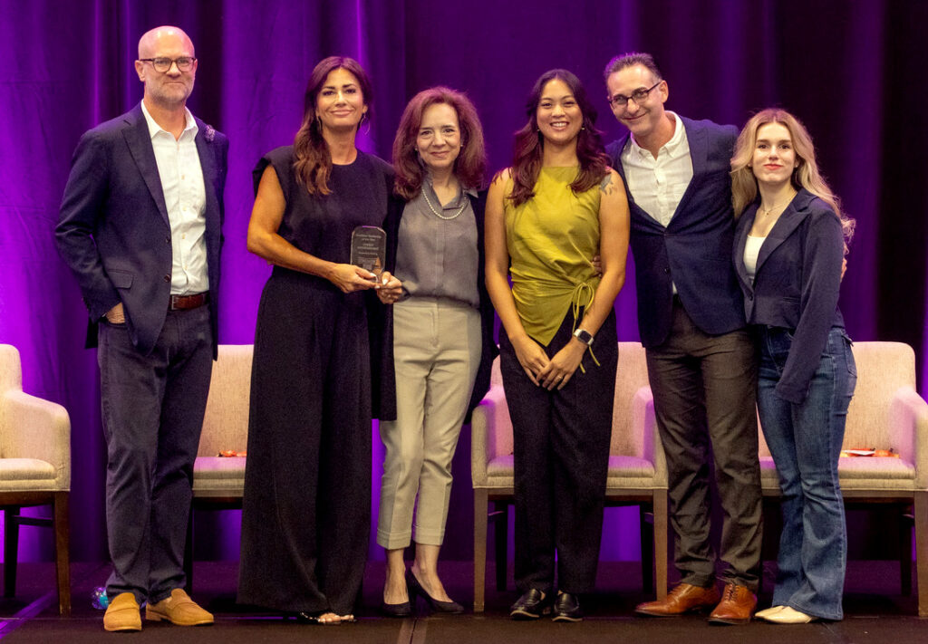 Brandon Jones of FilmFrog (left) presents the Exhibitor Marketing of the Year Award to Cinergy Entertainment, including Chief Marketing Officer, Traci Hanlon, Elizabeth Ramirez, Sydney Cruz, Jordan Michael, Melanie Yang during CinéShow 2026 in Dallas, Texas on 25 August, 2026. (Photo: CinéShow) receiving the Byron Berkley Leadership Award from Byron Berkley during CinéShow 2026 in Dallas, Texas on August 25, 2026.