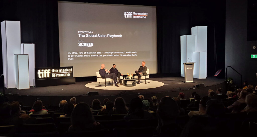 (From left) Roeg Sutherland, co-head of the Media Finance department and co-head of the International Film Group, and Glen Basner, founder and CEO of FilmNation Entertainment in conversation with moderator Geoff Macnaughton during the “Perspectives: The Global Sales Playbook” panel at TIFF: The Market. The session was held on 12 September. (Photo: Davide Abbatescianni)